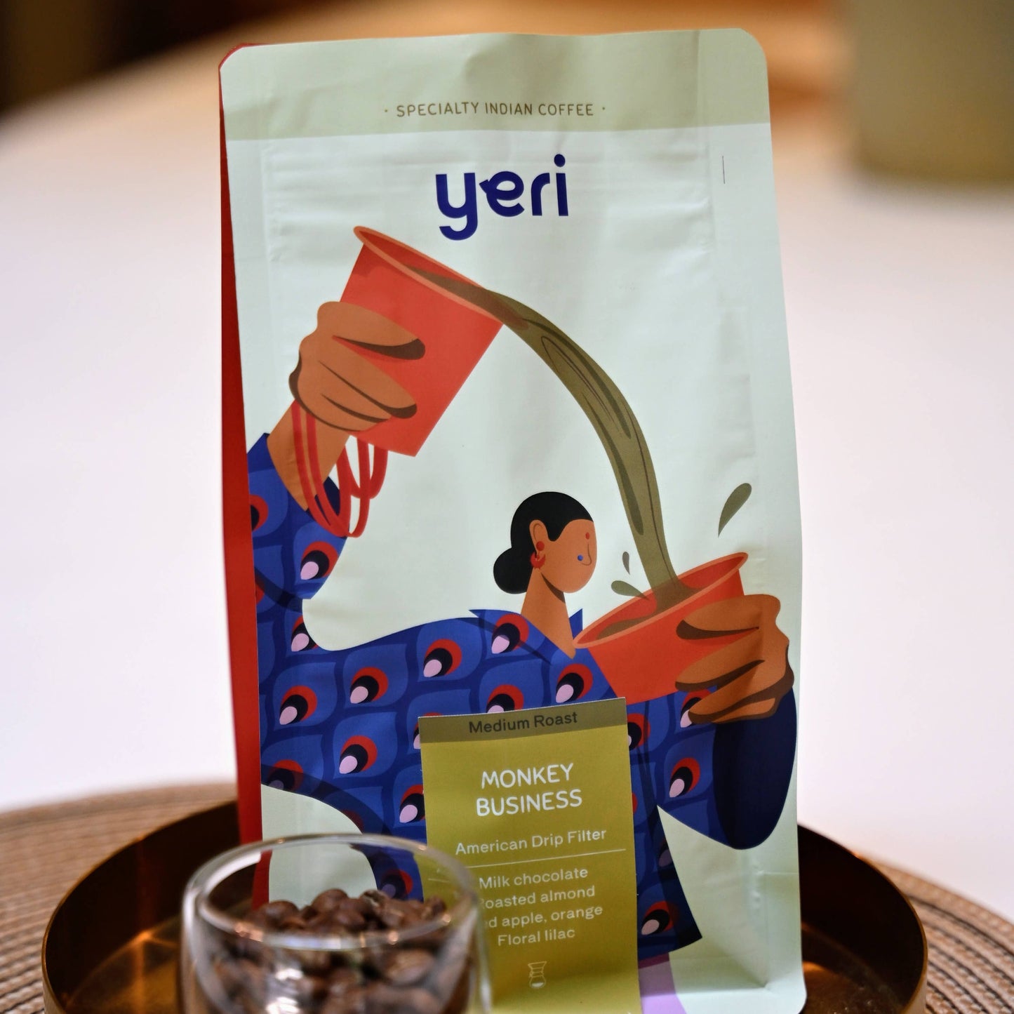 Yeri coffee package with a glass of coffee beans on a wooden tray
